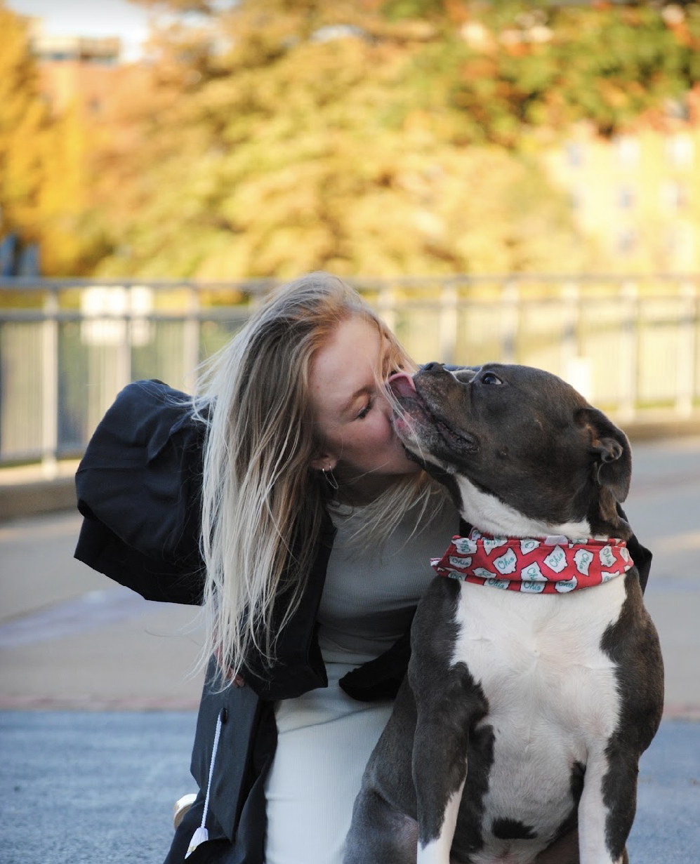 woman receives a puppy kiss
