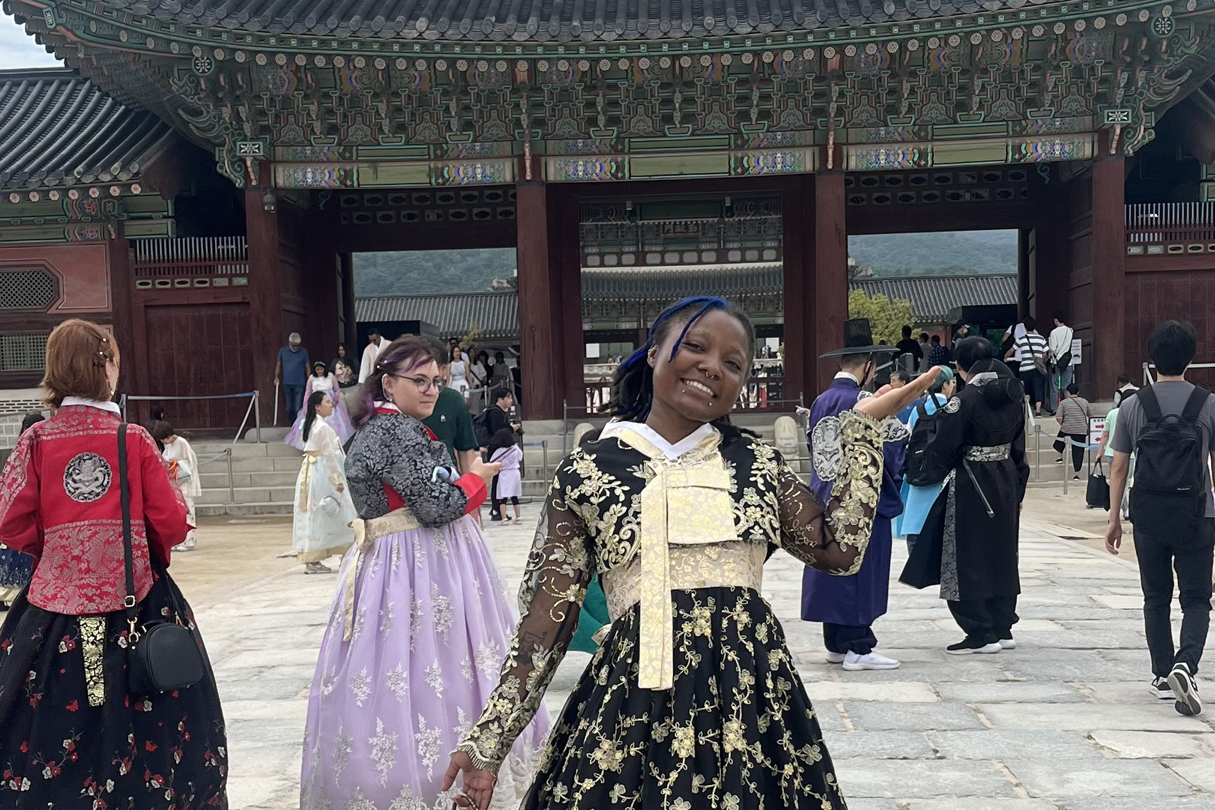 Student smiling in front of a temple in Korea