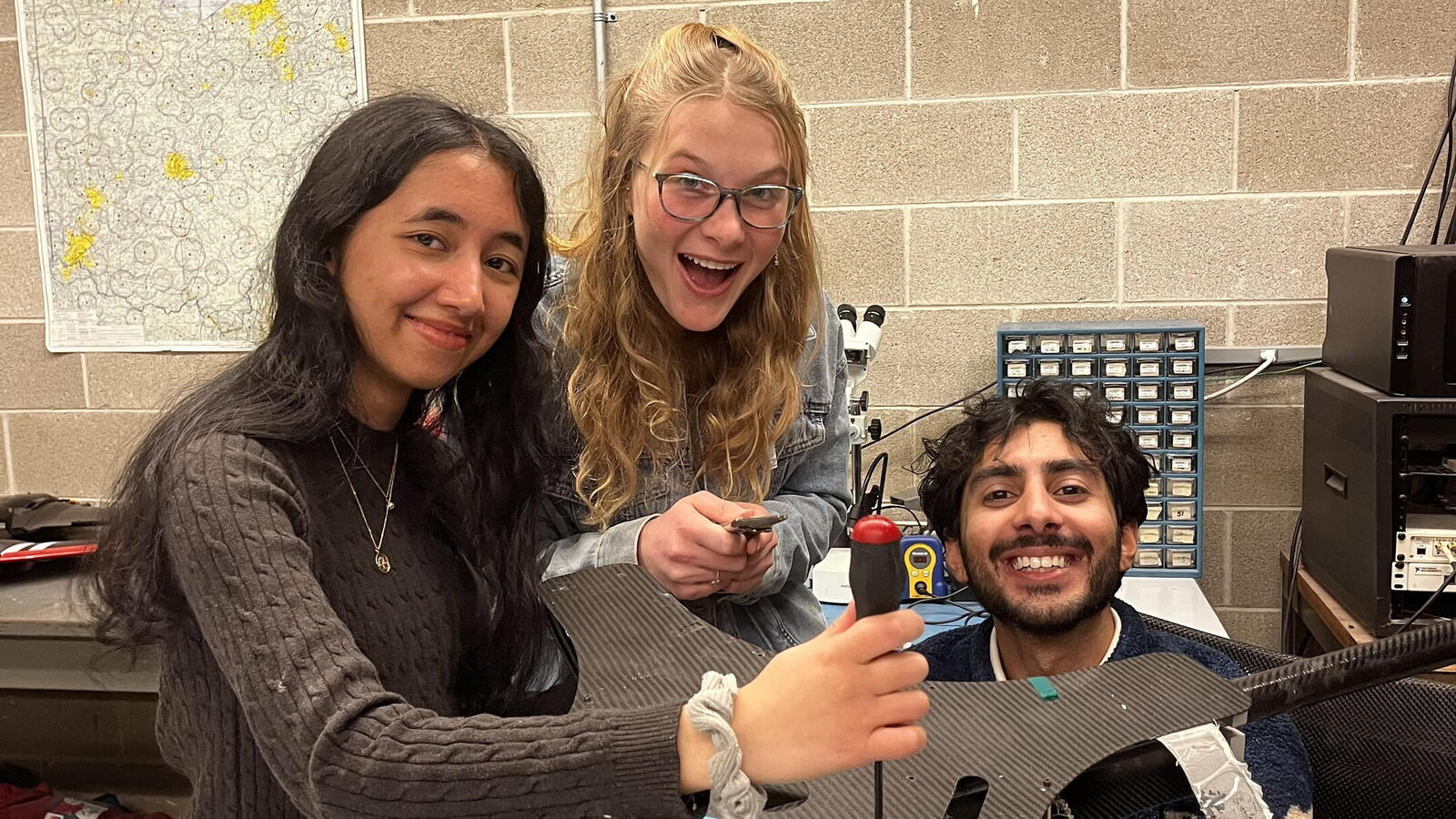 Students from The Sloopy Works team work on a benchtop model at The Ohio State University Aerospace Research Center.