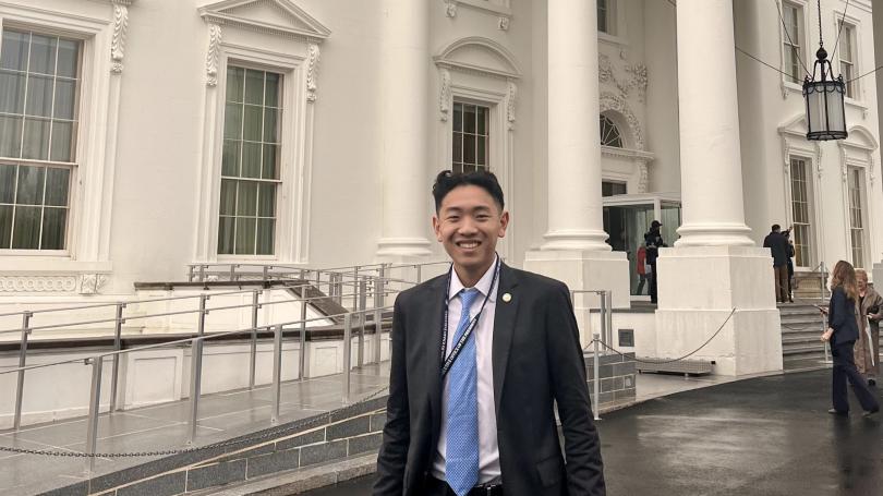 Lucas Tai stands in front of the White House