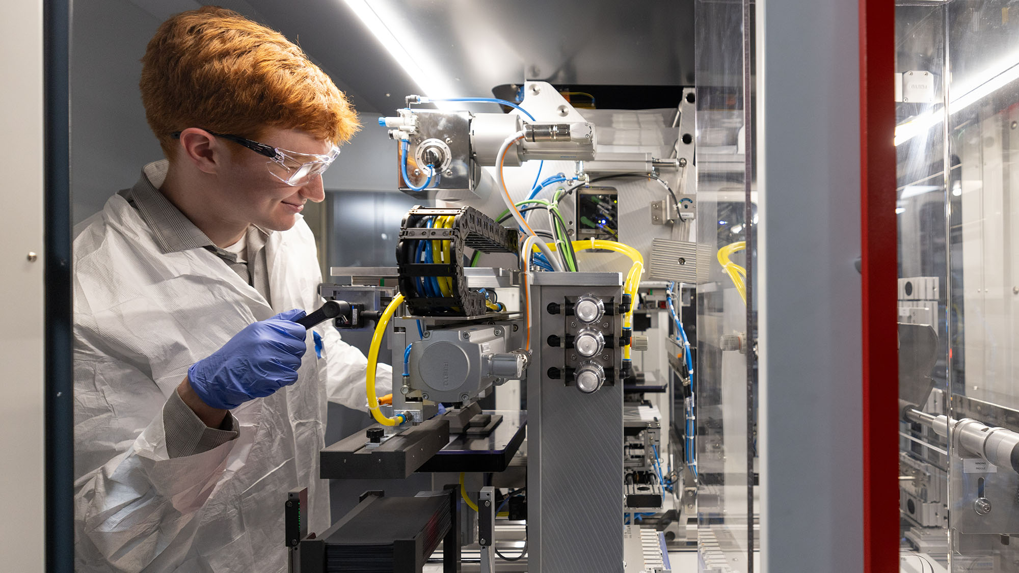 A stuend works on a developmental battery in a lab.