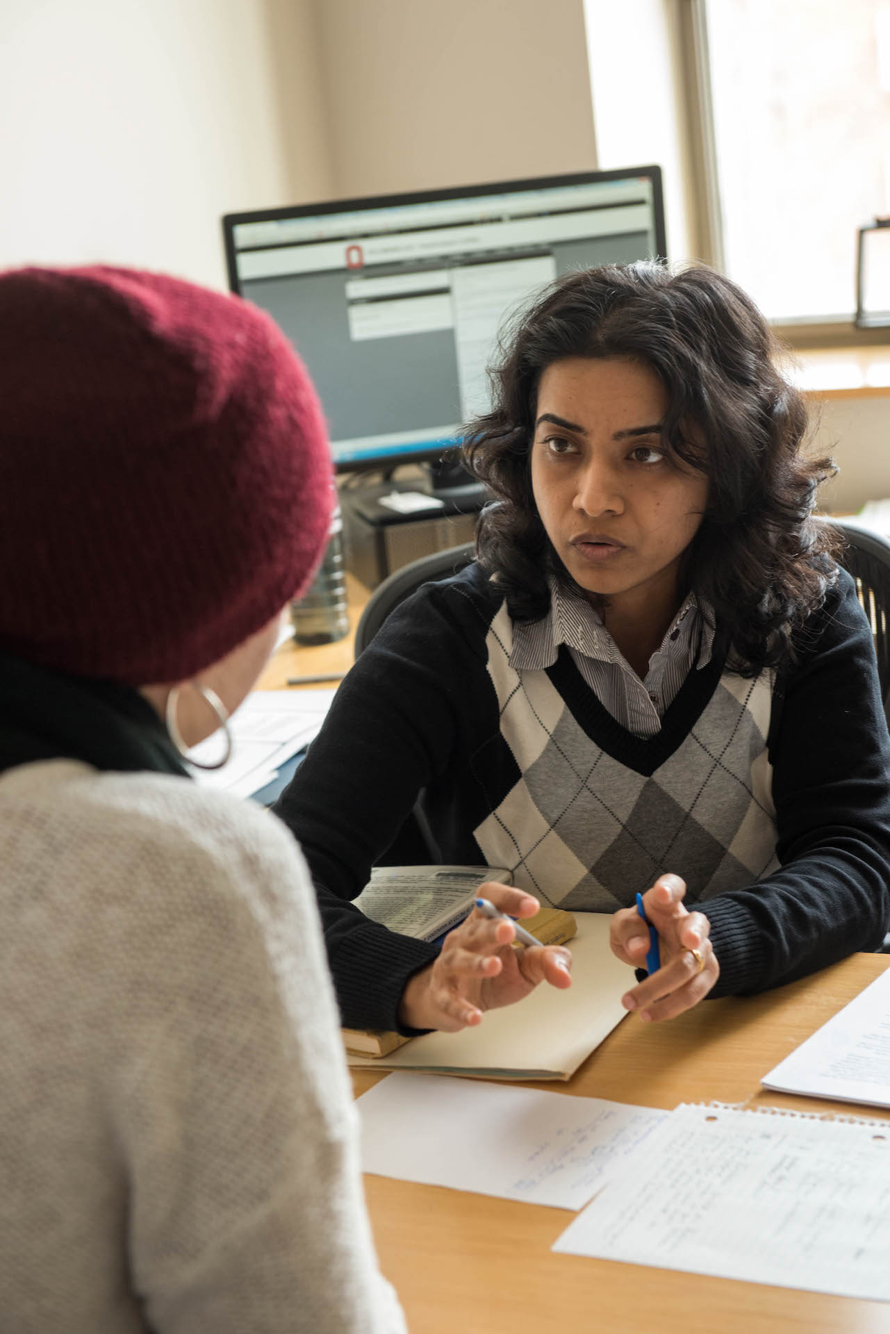 A faculty member reviews papers with a student.