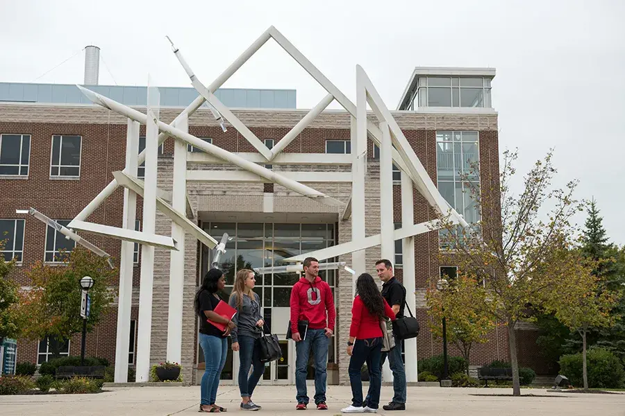 Lima campus with students standing outside on a cloudy day.