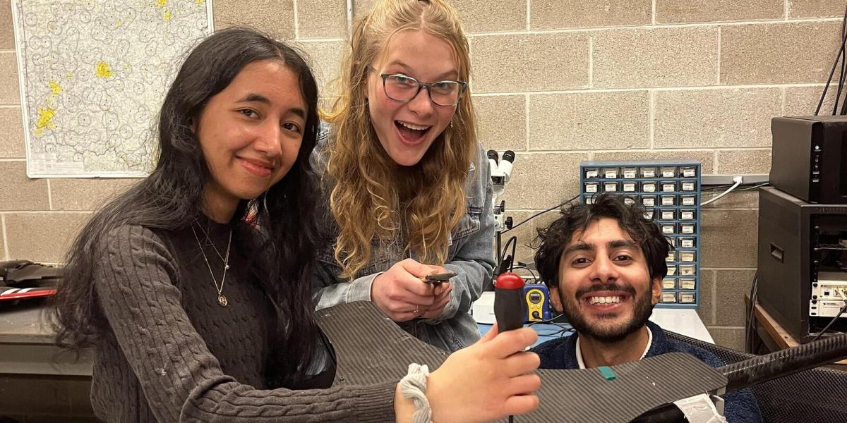 Students from The Sloopy Works team work on a benchtop model at The Ohio State University Aerospace Research Center.