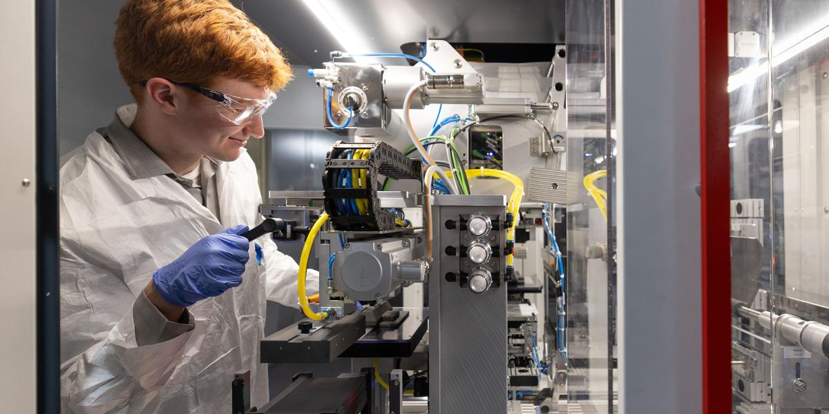 A stuend works on a developmental battery in a lab.