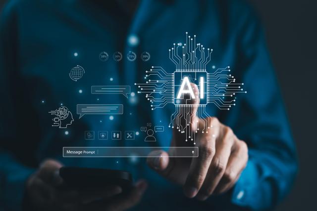 Person in blue shirt pressing on microchip with AI on it, message prompt box below that