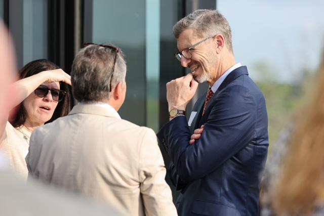 Interim Provost Trevor Brown speaks with guests at a public function.