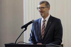 Candid photo of Provost Brown speaking at a podium.
